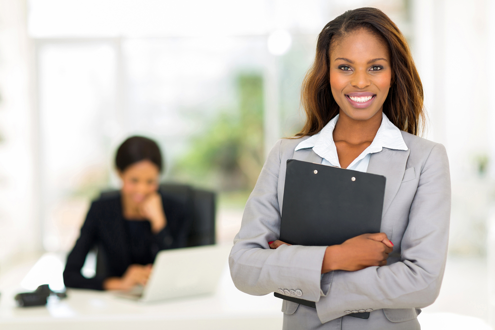 A female businesswoman smiling into the camera. 